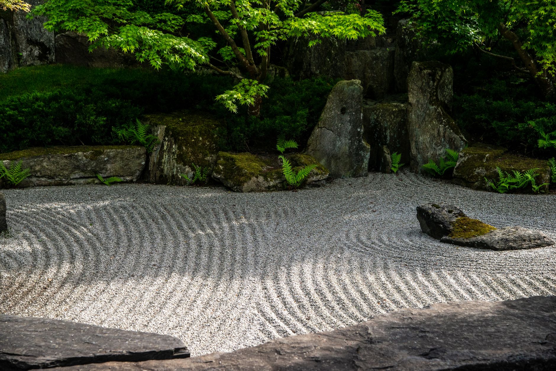 Raked gravel zen garden in Kyoto with stone arrangement
